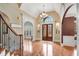 Elegant foyer with hardwood floors, chandelier, and arched doorways offering a glimpse into other rooms at 511 Baxter Way, Marietta, GA 30064
