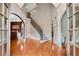 Grand two-story foyer with a curved staircase, hardwood floors, and elegant architectural details at 511 Baxter Way, Marietta, GA 30064