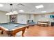 Expansive game room featuring a pool table, seating area, and a dining table for Gathering entertainment at 511 Baxter Way, Marietta, GA 30064