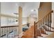 Hallway with hardwood floors, detailed wrought iron railing and a view to the windows and ceiling at 511 Baxter Way, Marietta, GA 30064