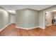 Hallway with pristine trim and laminate floors leading to additional rooms, showcasing the seamless flow at 511 Baxter Way, Marietta, GA 30064
