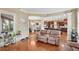 Open-concept living area with hardwood floors, large windows, and a view into the kitchen at 511 Baxter Way, Marietta, GA 30064