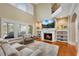 Bright living room with large windows, a cozy fireplace, built-in shelves, and comfortable seating at 511 Baxter Way, Marietta, GA 30064