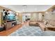 Inviting living room with a large sectional couch, entertainment center, and beach scene displayed on the television at 511 Baxter Way, Marietta, GA 30064