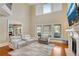 Airy living room with fireplace, large windows, and hardwood flooring, plus comfortable seating for relaxing at 511 Baxter Way, Marietta, GA 30064