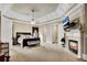 This main bedroom boasts a fireplace, a sitting area, plush carpets, and access to the ensuite at 511 Baxter Way, Marietta, GA 30064