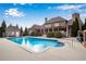 Stunning backyard pool with lush landscaping plus covered patio and beautiful brick home at 511 Baxter Way, Marietta, GA 30064