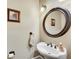 Charming powder room features a pedestal sink, decorative mirror, and stylish fixtures at 511 Baxter Way, Marietta, GA 30064