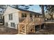 Rear view of a house with a wooden deck and stairs at 6454 Boca Grande Blvd, Forest Park, GA 30297