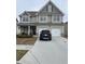 Two-story house with gray siding, two-car garage, and a landscaped front yard at 2398 Ticonic Rd, Lithonia, GA 30058