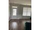 Front entry with a chandelier, hardwood floors, and white door at 2398 Ticonic Rd, Lithonia, GA 30058