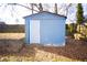 Blue shed in backyard with white door at 744 Law Nw St, Atlanta, GA 30318