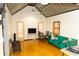 Bright living room features hardwood floors, high ceilings, and a comfy teal sofa at 744 Law Nw St, Atlanta, GA 30318