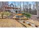 The backyard with landscaped pond, wooden deck, and rock garden at 298 Falcon Pointe Ct, Canton, GA 30114