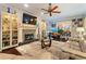 Bright living room featuring a fireplace, hardwood floors, ceiling fan, and natural light at 298 Falcon Pointe Ct, Canton, GA 30114