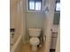 Compact bathroom with toilet, shower/tub combo, and vintage fixtures at 7 Quail Run, Decatur, GA 30035