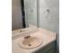 Bathroom featuring a rounded sink, mirror, and a towel ring on a textured blue wall at 7 Quail Run, Decatur, GA 30035