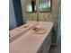 Bathroom vanity featuring dual mirrors and a neutral sink, offering potential for updates at 7 Quail Run, Decatur, GA 30035