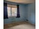 This bedroom features a large window providing natural light and blue walls with an empty carpeted floor at 7 Quail Run, Decatur, GA 30035