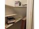 Organized closet with shelves and various items for a tidy and functional storage space at 7 Quail Run, Decatur, GA 30035