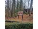 The Hillside Condos HOA Community sign surrounded by mature trees in a quiet neighborhood at 7 Quail Run, Decatur, GA 30035