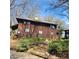 Two-story house featuring a stained wood exterior and a sloped, landscaped yard at 7 Quail Run, Decatur, GA 30035