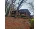 Two-story home with wood siding, multiple decks, and mature trees surrounding the property at 7 Quail Run, Decatur, GA 30035