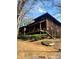 Two-story wood home featuring a covered porch with steps leading to the yard at 7 Quail Run, Decatur, GA 30035