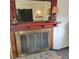 Close-up of the fireplace with a large mirror and a stone hearth beneath it at 7 Quail Run, Decatur, GA 30035