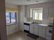 Kitchen with white cabinetry, tile countertops, an electric cooktop, and a stainless steel sink at 7 Quail Run, Decatur, GA 30035