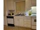 Galley kitchen with white cabinets and appliances at 7 Quail Run, Decatur, GA 30035