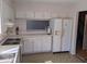 Kitchen with white appliances and cabinets, featuring a functional layout at 7 Quail Run, Decatur, GA 30035