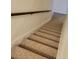 Carpeted staircase with a wooden handrail showcasing the home's interior design at 7 Quail Run, Decatur, GA 30035