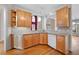 L-shaped kitchen with granite countertops and wood cabinets at 879 Ector Chase Nw, Kennesaw, GA 30152