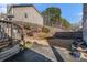 A tiered backyard includes a small patio, lush garden beds, and wooden fencing at 202 Bryon Ln, Acworth, GA 30102