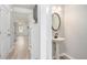 Entryway with half bath, pedestal sink, and mirror with views to the kitchen and living room at 202 Bryon Ln, Acworth, GA 30102