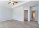 An unfurnished bedroom with light gray walls and flooring, a ceiling fan, and an ensuite bathroom and closet at 202 Bryon Ln, Acworth, GA 30102