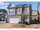 Two-story house with gray siding, white garage door, and landscaping at 202 Bryon Ln, Acworth, GA 30102