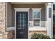 A stylish front door with glass panes welcomes you to the home at 202 Bryon Ln, Acworth, GA 30102
