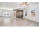Bright and airy living room featuring wood floors, a ceiling fan, and large windows at 202 Bryon Ln, Acworth, GA 30102