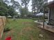 Spacious backyard with mature trees, swing set, patio furniture, and a trampoline at 2615 Leeshire Ct # 1, Tucker, GA 30084