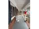 Covered porch with white railing and small table and chairs at 2615 Leeshire Ct # 1, Tucker, GA 30084