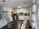 Bright kitchen features white cabinets, stainless steel appliances, and a dining area at 2615 Leeshire Ct # 1, Tucker, GA 30084