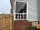 Side porch with white railing and brick foundation at 2615 Leeshire Ct # 1, Tucker, GA 30084