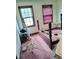 Bedroom with two windows, wood bed frame, and pink carpet at 804 Bankshire Dr, Suwanee, GA 30024