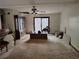 Spacious living room with a ceiling fan and sliding glass doors to the backyard at 804 Bankshire Dr, Suwanee, GA 30024