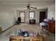 Spacious living room with a ceiling fan, piano, and ample natural light at 804 Bankshire Dr, Suwanee, GA 30024