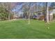 Large backyard with mature trees and a playset at 505 River Valley Rd, Sandy Springs, GA 30328