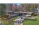 Beautiful home exterior featuring a spacious driveway, attached garage, and mature landscaping at 505 River Valley Rd, Sandy Springs, GA 30328