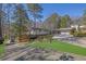 Stylish single-Gathering home with a long driveway, lush landscaping, and a two-car garage at 505 River Valley Rd, Sandy Springs, GA 30328